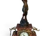statue of a woman holding a golf club on top of a clock