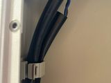 a close up of a black and red wire connected to a white wall