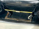 a black purse that is sitting on a table