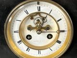 a black and gold clock on a black table