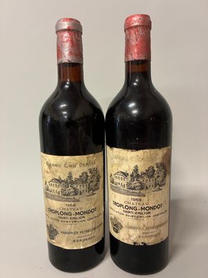 two bottles of wine sitting next to each other on a table