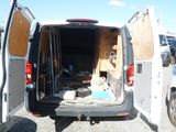 a white van with its doors open in a parking lot