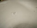 an image of a close up of a white vase with a label on it