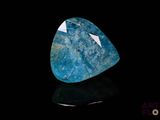 a close up of a blue stone on a black surface