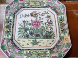 a plate with a picture of a bird and flowers on it