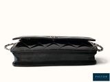 the small black purse is open on a white background