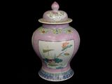 a vase with a lid that has flowers on it
