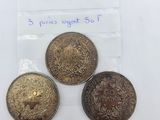 three coins in a bag with a price tag on them