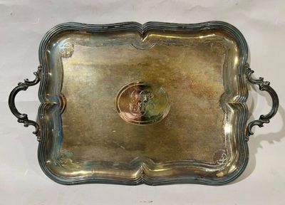 an antique silver tray with a coin in the middle of it