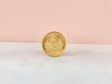 a gold coin sitting on top of a marble slab