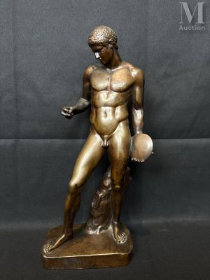a bronze statue of a man holding a ball and a dog