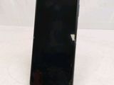 a close up of a cell phone on a stand on a table