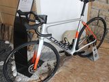 a bike that is sitting on the floor in front of a wall