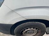 a white car with a flat tire on the street