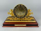 an image of a clock on a wooden base with a clock on top