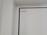 a white door with a black handle in a room