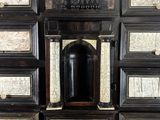 a black and white chest of drawers with a clock on it