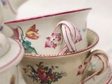 a tea pot and a tea cup on a plate