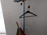 an image of a coat rack with umbrellas on it