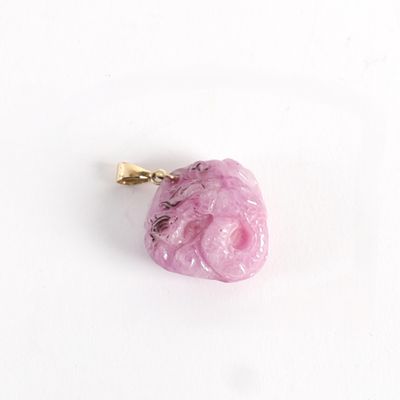 a pink heart shaped object on a white surface