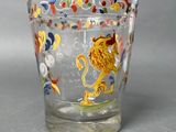 a glass cup with a design of a lion on it