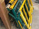 a pile of yellow and green ladders sitting on the floor