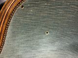a close up of a chair with a mirror on the back