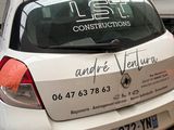 a white car parked in a garage with a sign on the back of it