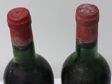 two bottles of wine that are sitting on a table