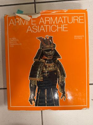 an orange book with a picture of an asian warrior on it
