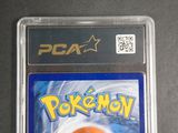 the pokemon card is in the plastic case on the table
