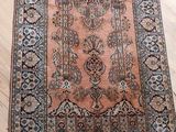 an antique persian rug on a wooden floor in a room