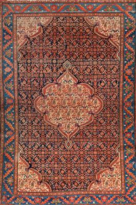 an antique persian rug with a medallion design on a blue ground