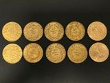 a group of gold coins sitting on top of a black surface