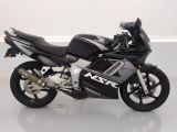 a black and silver motorcycle parked on a white floor
