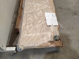 a pallet with a mattress on it in a warehouse