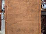 a wooden cabinet in the middle of a room