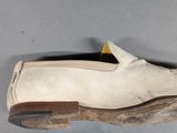a pair of shoes hanging from a shoe rack