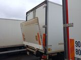 two trucks parked next to each other in a parking lot