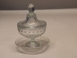 a small glass bowl with a lid on a table