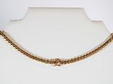 a close up of a gold chain necklace on a mannequin mannequin