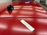 a sticker on the hood of a red car