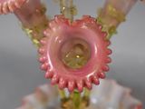 a close up of a vase with pink flowers in it
