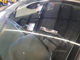 a car that has a sticker on it ' s windshield