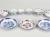 a group of blue and white plates and bowls