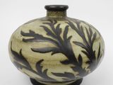 a black and white vase on a white surface