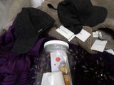 a jar of clothes and a pair of gloves on a bed