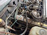 an old car engine with a lot of wires attached to it