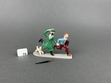 two figurines of a man and a dog on a table