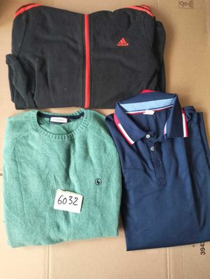 three men ' s sweaters are sitting on top of a cardboard box